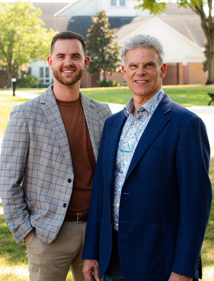 A father and son working together in an office, representing a family business.